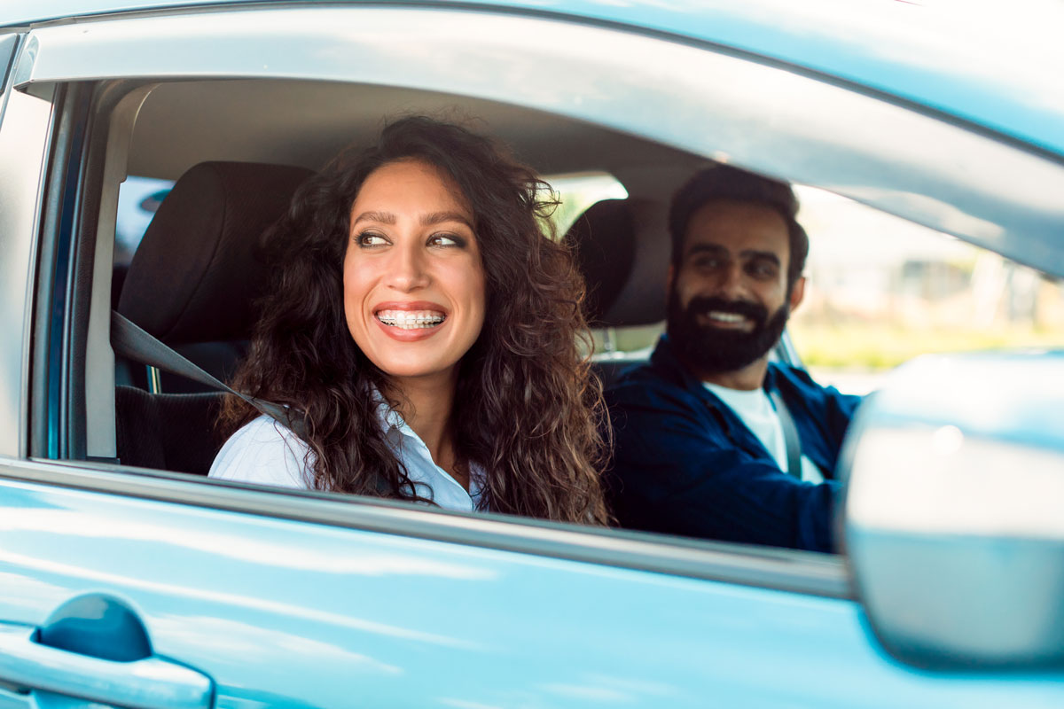 family with driving happily with auto insurance coverage